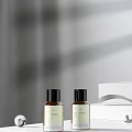Elegant Perfume Cosmetics Two Brown Bottles With Black Caps And White Box On