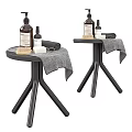 Bathroom Accessories On Black Side Tables With Bottles Soap Towel And Brush