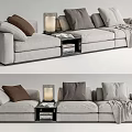 Gray Sectional Sofa With Multiple Pillows Side Table Lamp Books And Throw Blanket 3d model