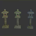 Three Stone Lanterns With Mossy Green And Light Stone Bases And Rounded Tops