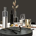 Elegant Dinnerware Set on Marble Tabletop with Black Plates Golden Cutlery Glassware and Accessories