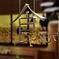 Hanging Metal Pendant With Chinese Character He And English Word Food In Indoor Setting