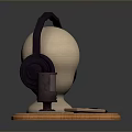 Headphones and Microphone Electronic Device on Mannequin Head Display with Wooden Base