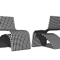 Two Modern Black And White Striped Lounge Chairs With Curved Structure And Unique Design