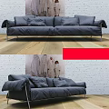 Grey Upholstered Two Seater Sofa With Metal Legs On Wooden Floor And Brick Wall