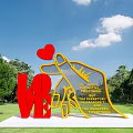 Red LOVE And Yellow Hand Sculpture Photo Spot With Pointing Red Heart And Inscribed Text