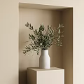 White Vase With Green Olive Branches in Beige Wall Corner on Light Colored Cube Stand
