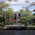 Serene Garden Landscape with Waterfall Pond Red Maple Trees Traditional Pavilion and Lush Green Shrubs