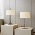 Two Modern Floor Lamps With White Fabric Shades And Metal Stands On White Cube Bases