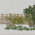 Decorative Garden Wall With Wooden Fence Covered In Yellow Flowers And Green Plants