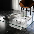 Sleek Modern Coffee Table Featuring Glass Top Marble Base And Decorative Magazines
