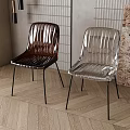 Modern Metallic Dining Chairs With Black Metal Legs On Wooden Floor And Green Plant