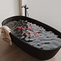 Black Oval Bathtub With Rose Petals And Towel On Wooden Floor Near Window Blinds