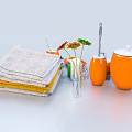 Bathroom Accessories Featuring Stack of Gray Yellow Towels Orange Cups Toothbrushes Vase with Flowers