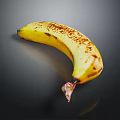 Yellow Banana With Brown Spots On Black Background Showing Reflective Surface