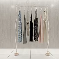Golden Metal Clothes Rack With Hanging Clothes On Grey Wall White Tiled Floor
