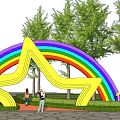 Rainbow Colored Star Shaped Entrance Gate with Moon Decorations Surrounding Trees and People Nearby