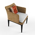 Stylish Wicker Armchair With Black Legs White Cushion And Red Patterned Pillow