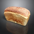 Freshly Baked Golden Crust Bread With Soft Interior On Black Surface