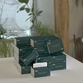 Stacked Green Decorative Tissue Boxes With Natural Plants In Home Setting