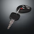 Black Car Key Fob With Remote Control And Metal Key Blade On Dark Surface