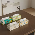 Four Colorful Tissue Boxes With Different Patterns On Wooden Table