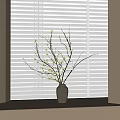 Minimalist Ceramic Vase With White Small Flowers And Branches On Window Sill By Window Blinds