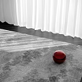 Square Area Rug In Gray Pattern With Red Ball And White Curtains In Bright Light