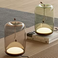 Modern Glass Bell Shaped Table Lamps With Transparent Shade And Warm Light On Books