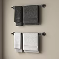 Black and White Towels Hanging on Wall Mounted Towel Racks in Modern Bathroom