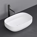 Modern White Oval Shaped Countertop Washbasin with Black Faucet on Dark Surface