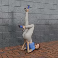Woman Doing Handstand In Blue Top Gray Pants Blue High Heels Against Gray Brick Wall