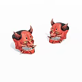Two Red Devil Masks With Horns And Yellow Eyes As Decorative Ornaments