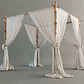 Elegant Bamboo Frame Tent With White Drapery And Decorative Flower Accents