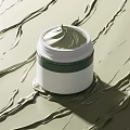 Green Face Cream Jar with Smooth Texture and White Green Packaging Design