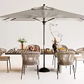 Outdoor Garden Table With Large Umbrella Chairs Fruits Vase And Flowers