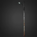 Outdoor Street Light with Curved Arm and Metal Pole Lit Up Bright White at Night