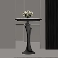 Modern Side Table with Round Tabletop Silver Base and Vase of White Flowers
