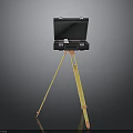 Black Electronic Device Mounted On Yellow Tripod Stand For Portable Use