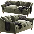 Green Velvet Two Seater Sofa with Dark Pillows and Black Throw Blanket and Wooden Legs