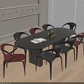 Oval Black Dining Table and Red Black Chairs in Bright Interior with Fruits and Napkin