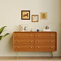 Wooden Console Table With Drawers Golden Handles And Green Plant Near Wall Art