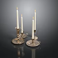 Lit White Candles On Decorative Metal Candle Holders With Intricate Patterns