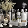 Stylish Bathroom Accessories Including Fragrance Candles Hand Soap Bottles and Decorative Shells