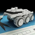 White Model Armored Vehicle With Large Wheels On Blueprint With Scissors
