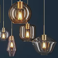 Modern Glass Pendant Lights In Various Shapes With Golden Metal Frames And Illuminated Bulbs