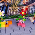 Popular Mall Photo Check in Spot With Colorful Seats Large Flower Decorations And Green Plants