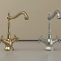 Two Gold and Silver Faucets on Gray Countertop with Light Colored Wall