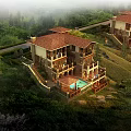 Detached Villa on Hillside with Lush Green Surroundings Swimming Pool and Red Tile Roof