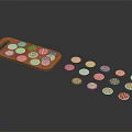Small Round Pastries Placed On Red Tray With Scattered Pieces Around